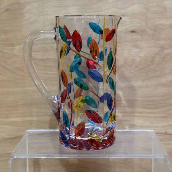 Clear glass pitcher with colorful leaf pattern