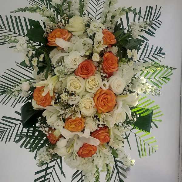 Standing floral spray with white and orange roses and lilies