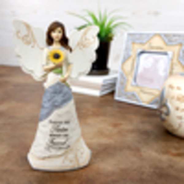 Angel figurine holding a sunflower with wings and a memorial-style dress