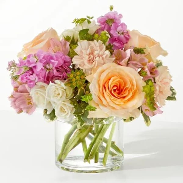 Pink and peach mixed bouquet in a clear glass vase
