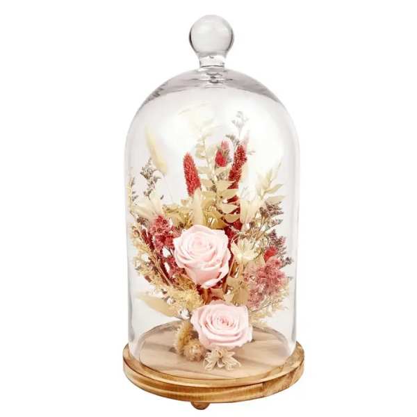 Two pale pink roses under a glass dome on a wooden base
