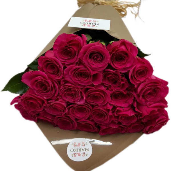 Bouquet of hot pink roses wrapped in brown paper