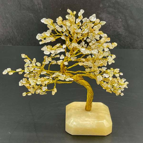 Decorative crystal tree sculpture on a stone base