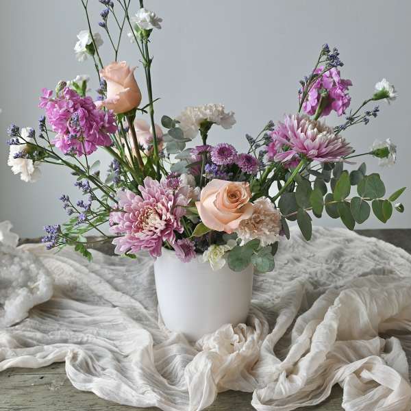 Pink and white mixed bouquet in a white vase