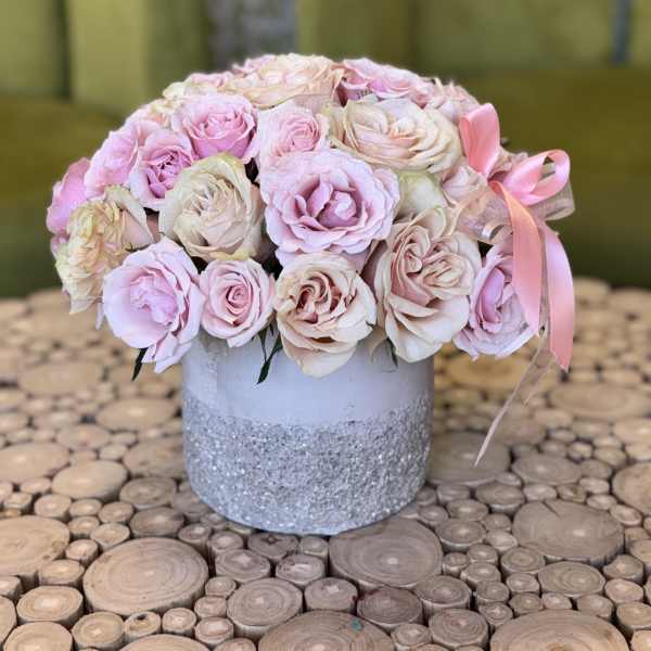 Pink and cream rose bouquet in a glittered silver vase with ribbon