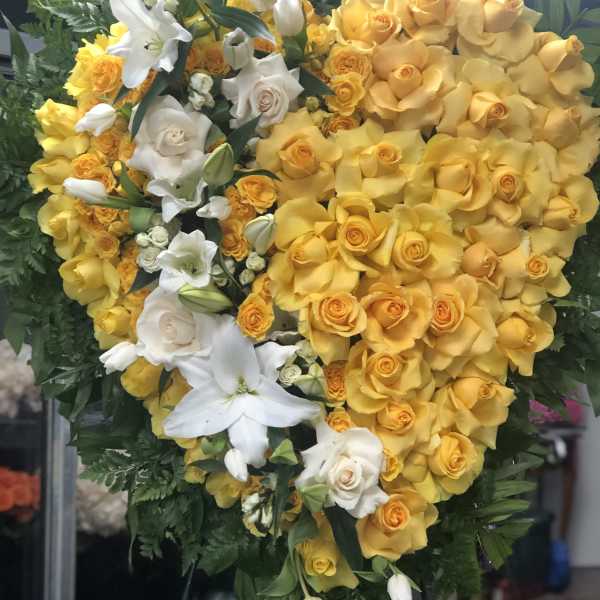 Heart-shaped bouquet of yellow and white roses with lilies