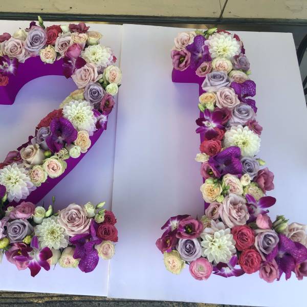 Floral number 21 made of pink, purple, and white flowers