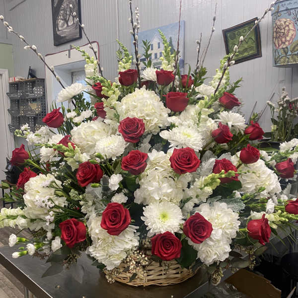 Large basket arrangement of red roses and white flowers