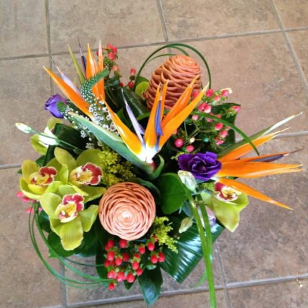 Tropical bouquet with orange bird-of-paradise and orchids