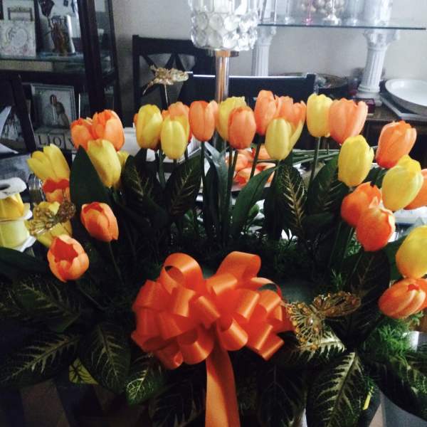 Bouquet of orange and yellow tulips with a large orange ribbon