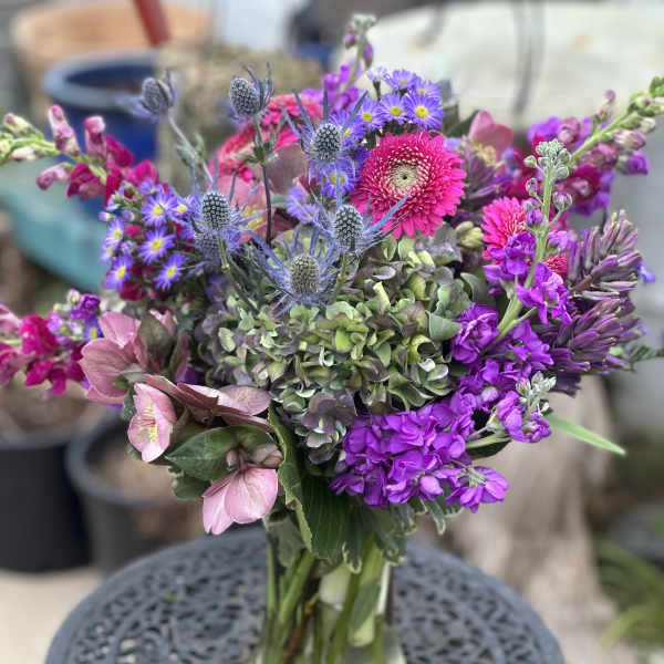 Mixed purple and pink bouquet in a glass vase