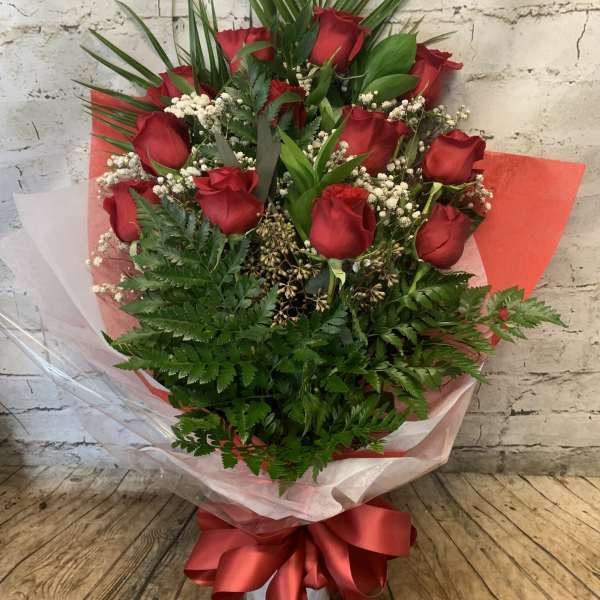 Bouquet of red roses with baby's breath and a red ribbon wrap