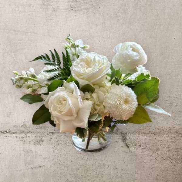 White floral bouquet in a clear glass vase