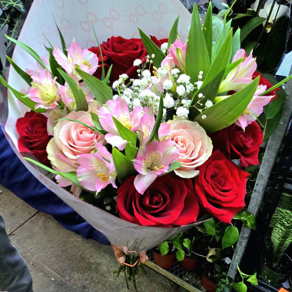 Bouquet of red and pink roses with pink alstroemeria