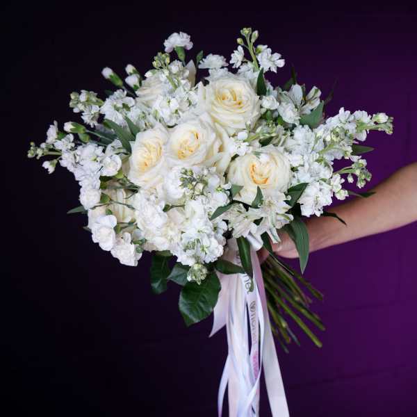 White rose bouquet with small white filler flowers and ribbon streamers