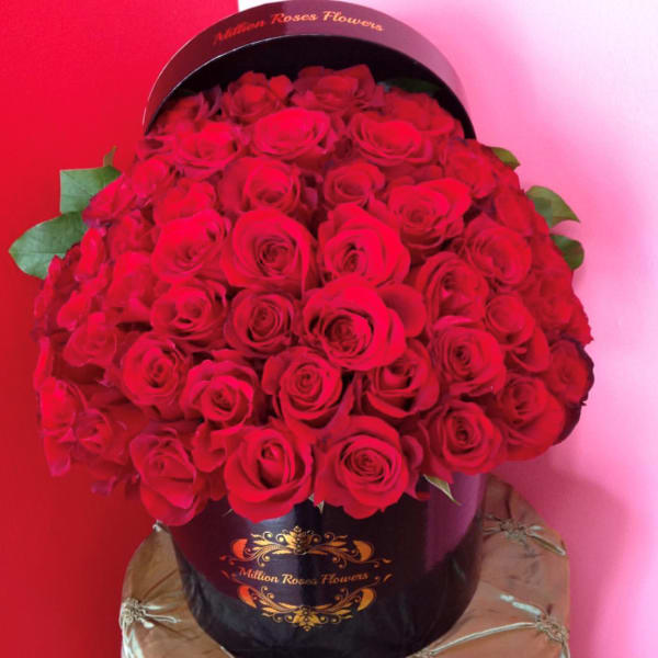 Large bouquet of red roses in a black hatbox