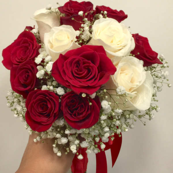 Bouquet of red and white roses with baby's breath and a red ribbon