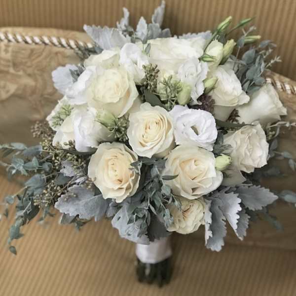 White rose bouquet with gray foliage and a wrapped handle