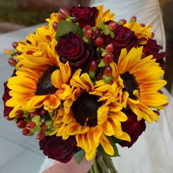 Bouquet of yellow sunflowers and deep red roses