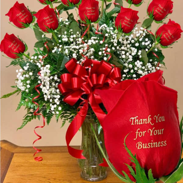 Bouquet of red roses with a red ribbon in a glass vase