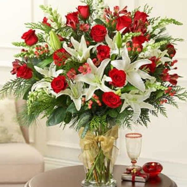 Bouquet of red roses and white lilies in a clear glass vase