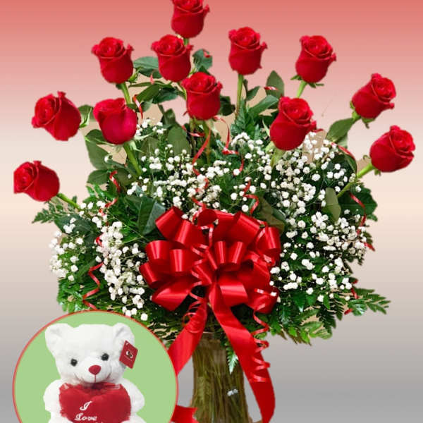 Red roses in a glass vase with baby's breath and a teddy bear inset