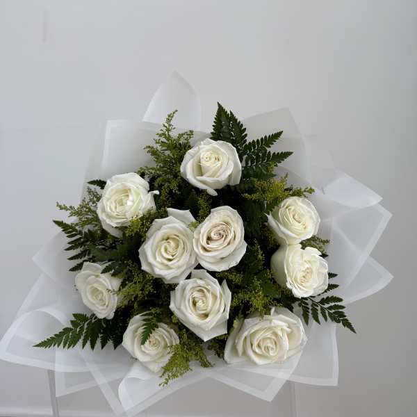 Bouquet of white roses with greenery and white wrap