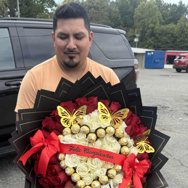 Large bouquet of red and white roses with gold chocolates and butterfly decorations