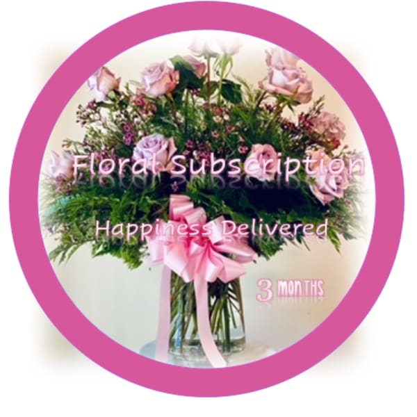 Pink rose bouquet in a glass vase with a ribbon