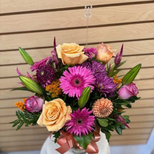 Bouquet of pink and peach flowers with a satin ribbon