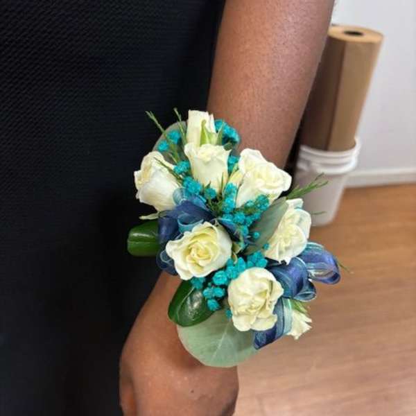 White rose wrist corsage with blue ribbon and turquoise accents