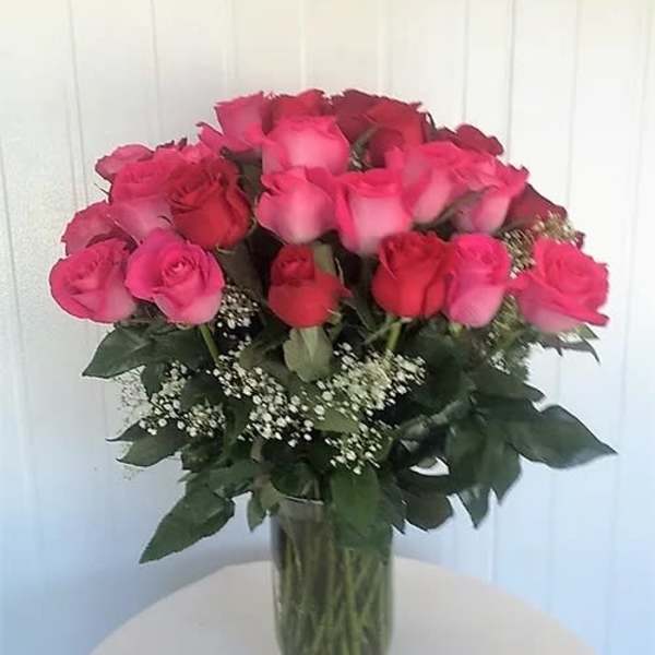 Bouquet of pink and red roses in a clear glass vase