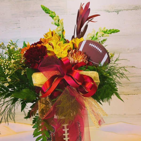 Football-themed bouquet with yellow and burgundy flowers and ribbon
