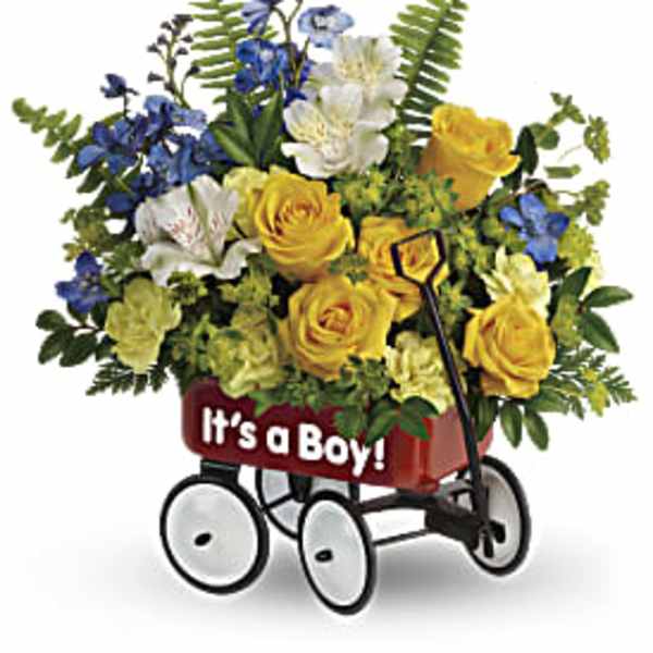 Yellow and blue flower arrangement in a red “It’s a Boy!” toy wagon container