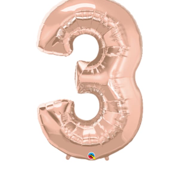 Rose gold foil balloon shaped like the number 3