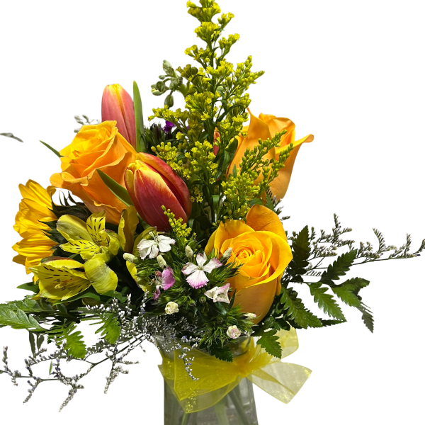 Yellow roses and tulips in a clear glass vase with a yellow ribbon