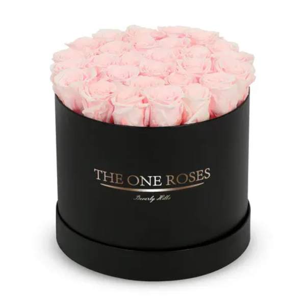 Pink roses arranged in a black round box