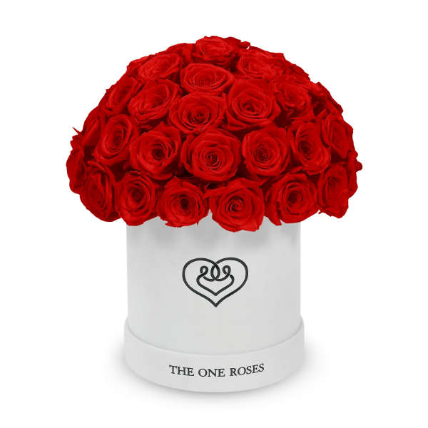 Red roses arranged in a white round box with a heart logo