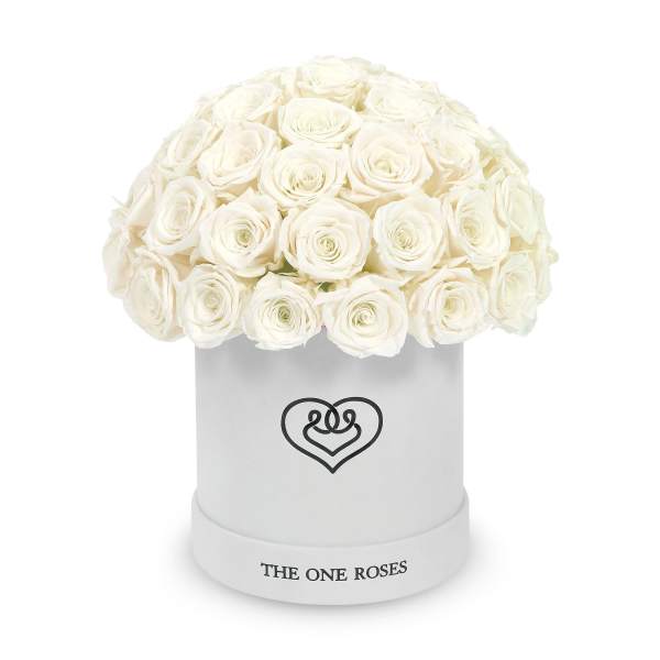 White roses arranged in a round hatbox with a heart logo