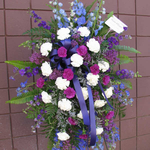 Tall standing floral spray with purple, blue, and white flowers