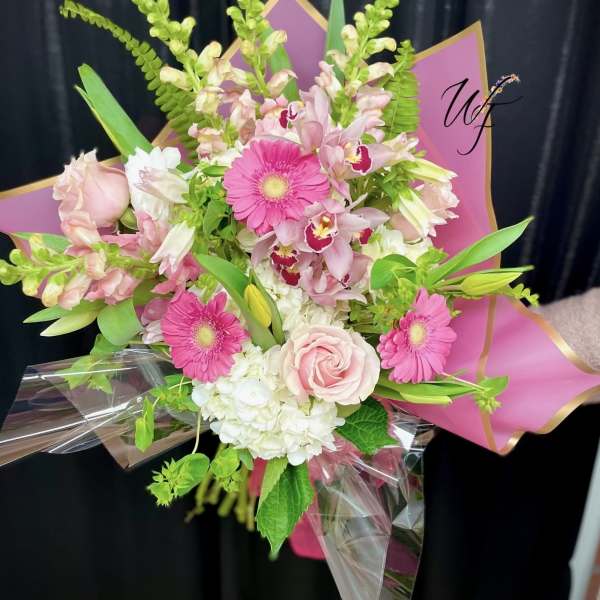 Pink and white mixed bouquet with gerbera daisies, roses, and orchids