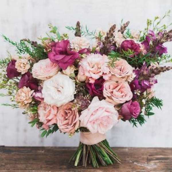 Bouquet of blush and magenta roses with mixed greenery