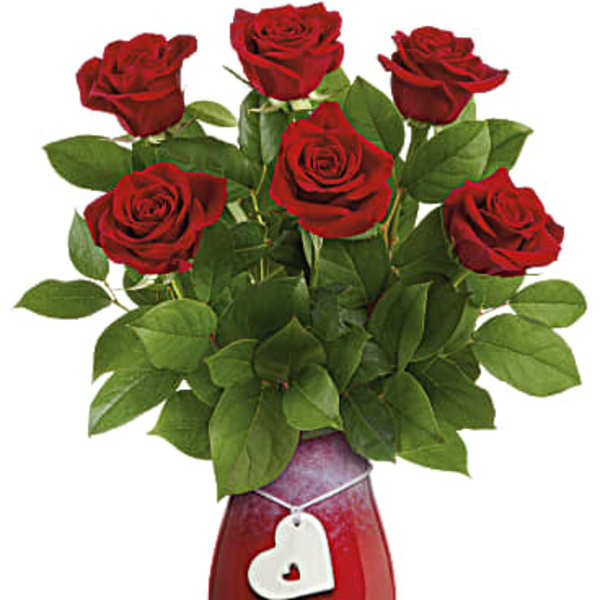 Red roses in a red vase with a white heart tag