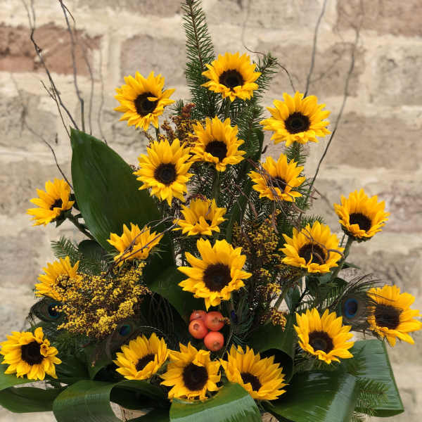 Basket arrangement of yellow sunflowers with dark centers