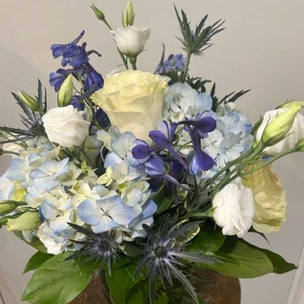 Bouquet of blue and white flowers in a vase