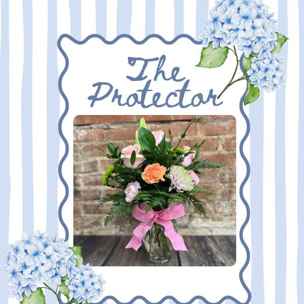 Bouquet of mixed flowers in a glass vase with a pink ribbon