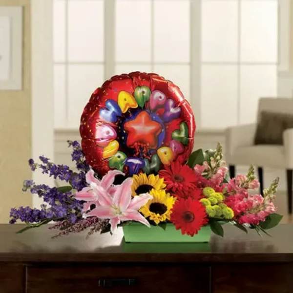Colorful flower arrangement with a heart balloon and sunflowers