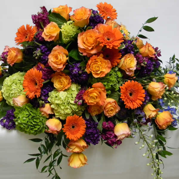 Large bouquet of orange roses, gerbera daisies, and purple flowers