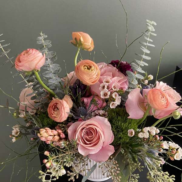 Pink and peach mixed bouquet in a white vase