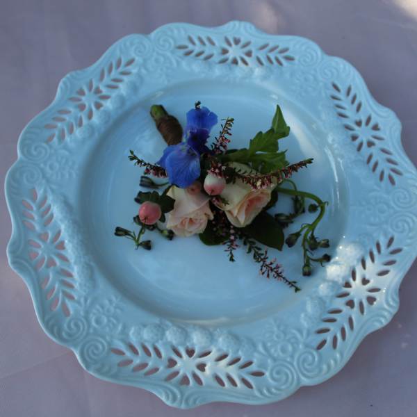 Small floral corsage on a decorative blue plate